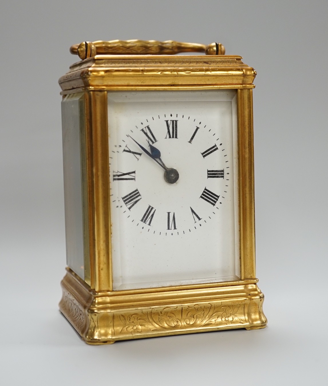 A late 19th century French eight day timepiece, in an engraved brass gorge case. 12cm tall